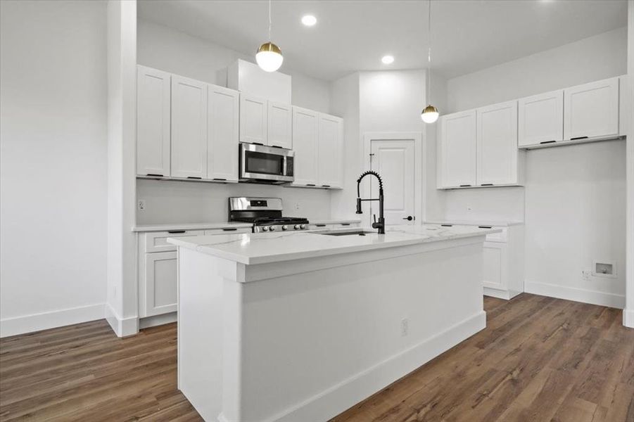 Kitchen with pendant lighting, white cabinetry, stainless steel appliances, dark wood-style floors, and recessed lighting