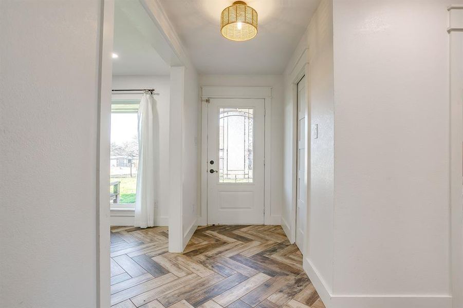 Foyer featuring parquet flooring and baseboards