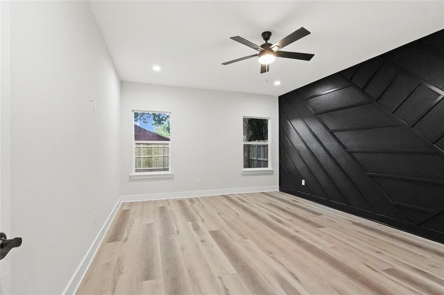 Unfurnished room featuring ceiling fan and light hardwood / wood-style floors