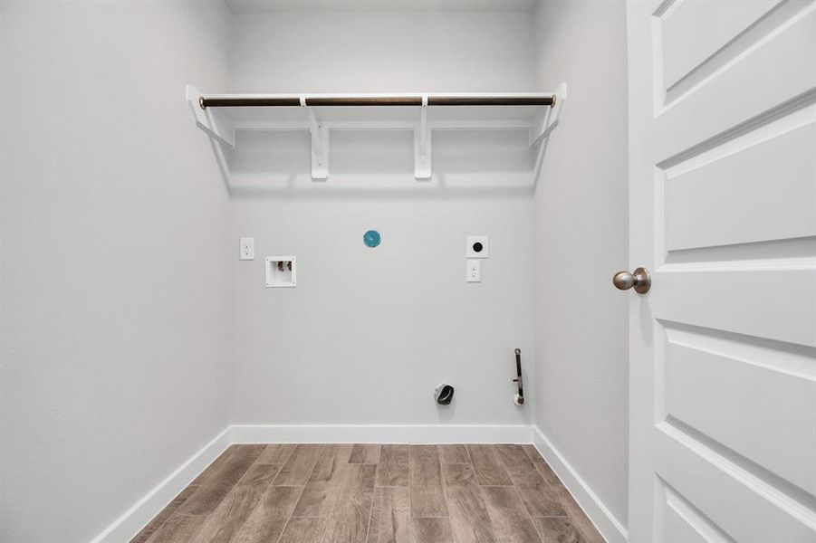 Utility room in home. Both electric and gas dryer connections. Sample photo of completed plan. As built color and selections may vary.