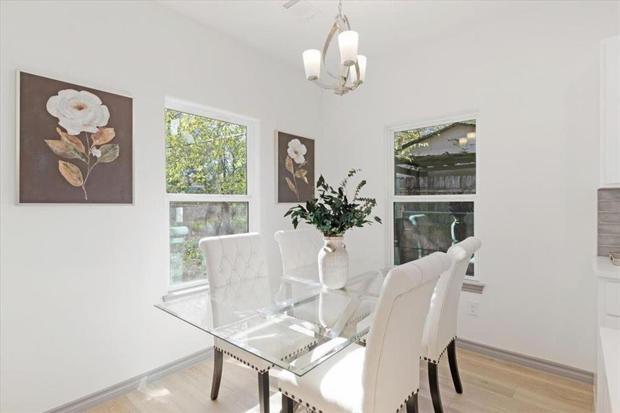 Dining space featuring a chandelier and light hardwood / wood-style floors