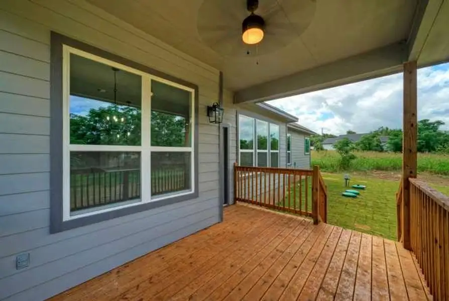 A spacious wooden deck provides ample outdoor living space, perfect for enjoying tranquil views.