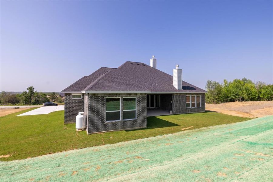 View of side of property featuring a lawn