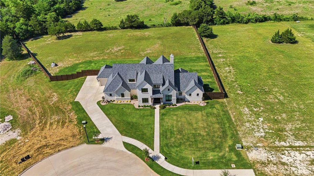 Expansive property featuring a contemporary residence with a multi-gabled roofline and light-colored siding