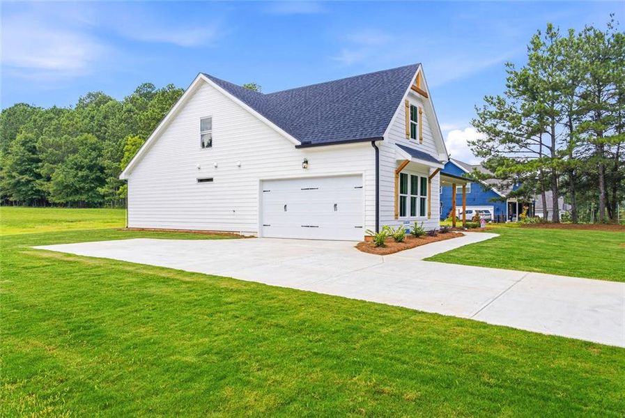 Front exterior of a new home in , Mansfield, GA, highlighting curb appeal (Image 1). Front exterior of a new home in , Mansfield, GA, highlighting curb appeal (Image 1).