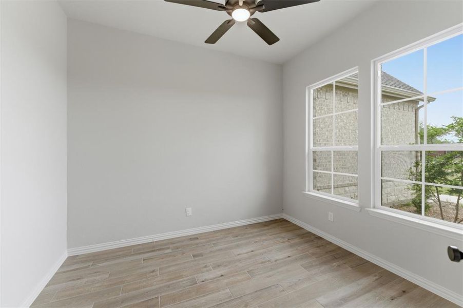 Unfurnished room with light wood-style floors and ceiling fan