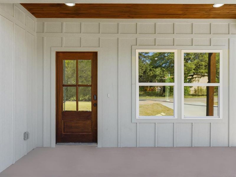Doorway to property with board and batten siding Doorway to property with board and batten siding