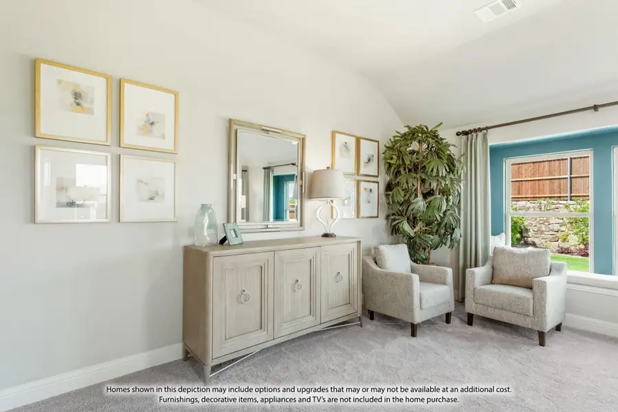Sitting room with vaulted ceiling, light wood credenza, two gray armchairs, and framed wall art on carpet Sitting room with vaulted ceiling, light wood credenza, two gray armchairs, and framed wall art on carpet