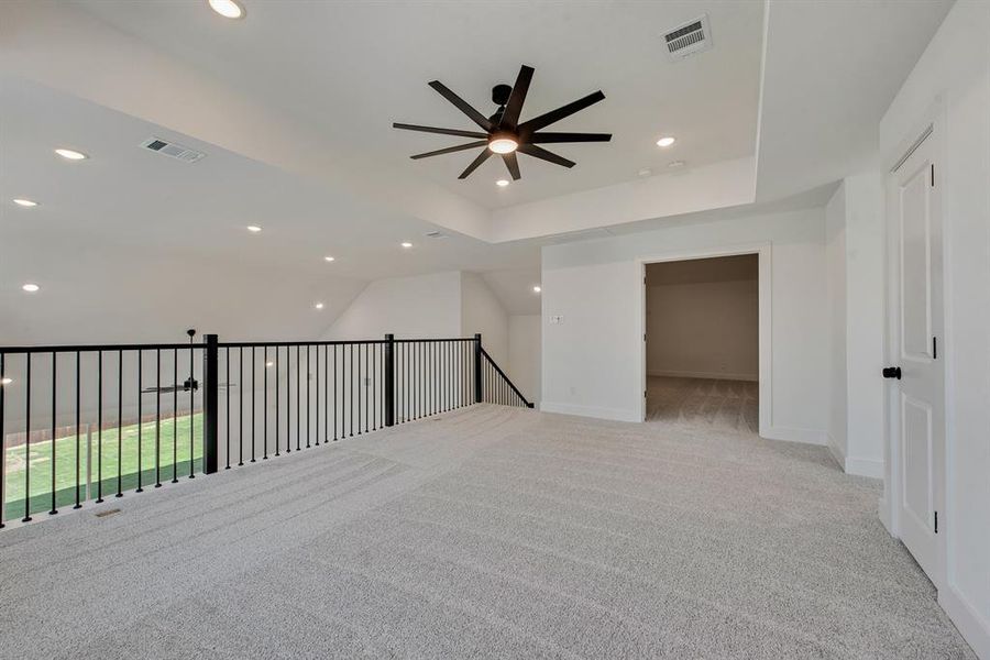 Unfurnished room with recessed lighting, light carpet, a ceiling fan, and vaulted ceiling Unfurnished room with recessed lighting, light carpet, a ceiling fan, and vaulted ceiling