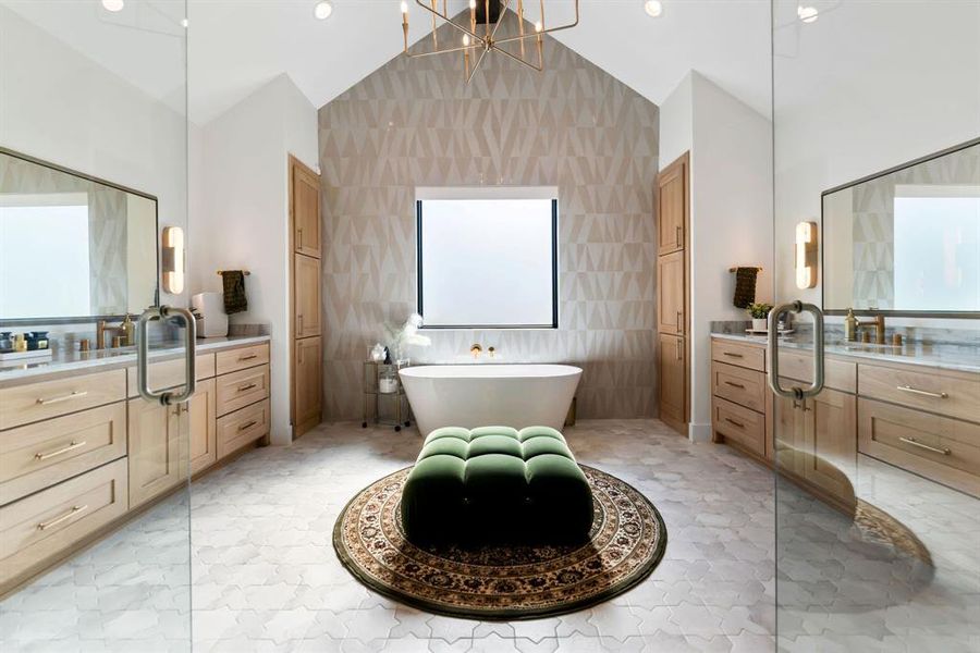 Bathroom featuring a freestanding tub, tile walls, vanity, lofted ceiling, and a chandelier Bathroom featuring a freestanding tub, tile walls, vanity, lofted ceiling, and a chandelier