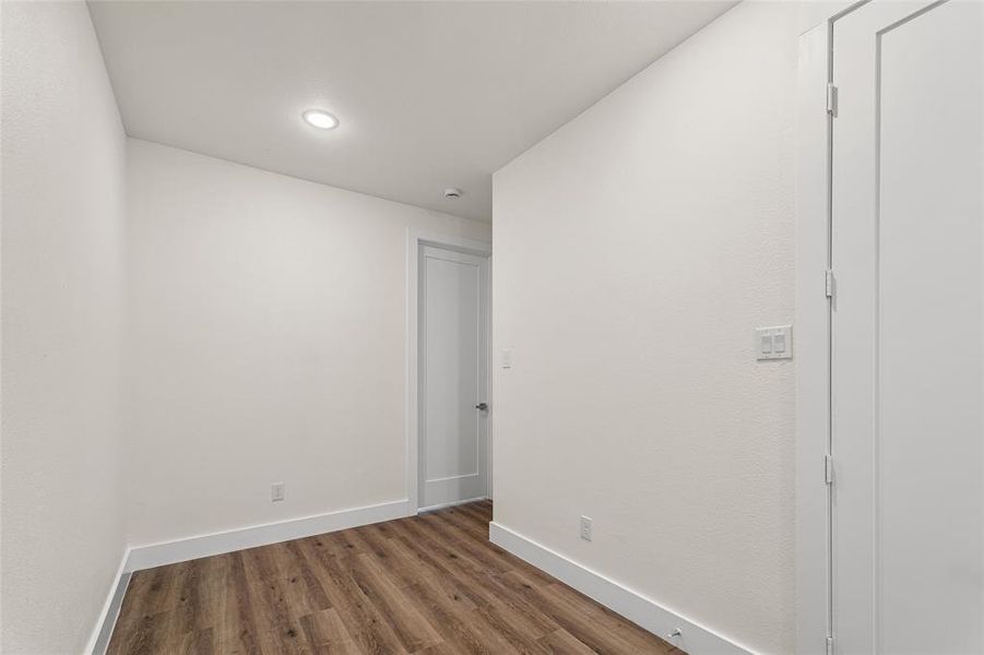 Unfurnished room featuring wood finished floors and recessed lighting Unfurnished room featuring wood finished floors and recessed lighting