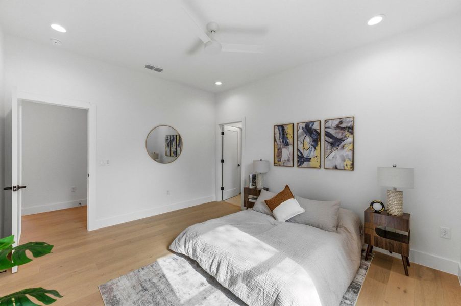 Bedroom featuring light wood-type flooring, a ceiling fan, and recessed lighting