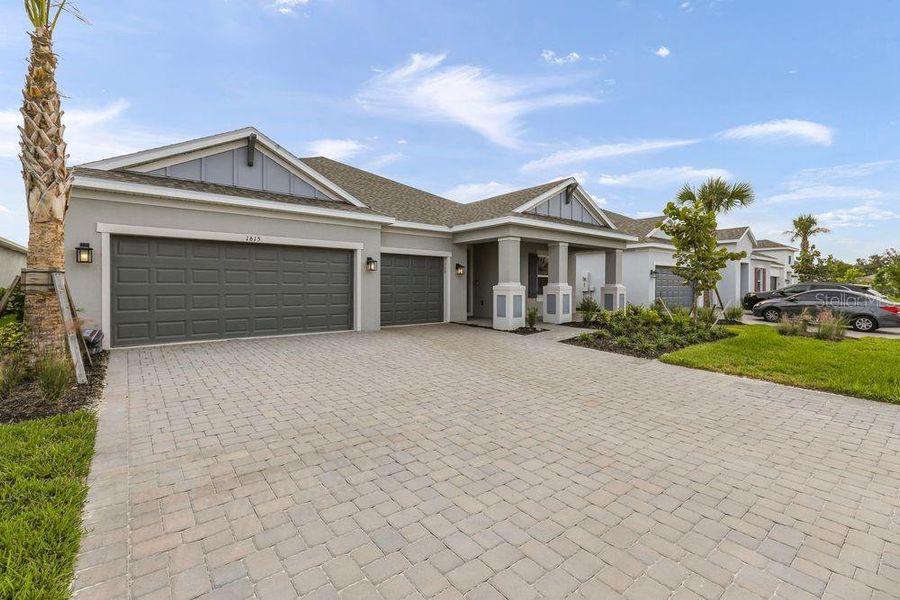 Front exterior of a new home in The Cove at West Port, Port Charlotte, FL, highlighting curb appeal (Image 2).