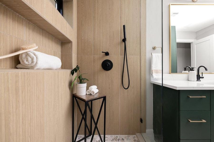 Bathroom featuring vanity, walk in shower, and tile patterned floors