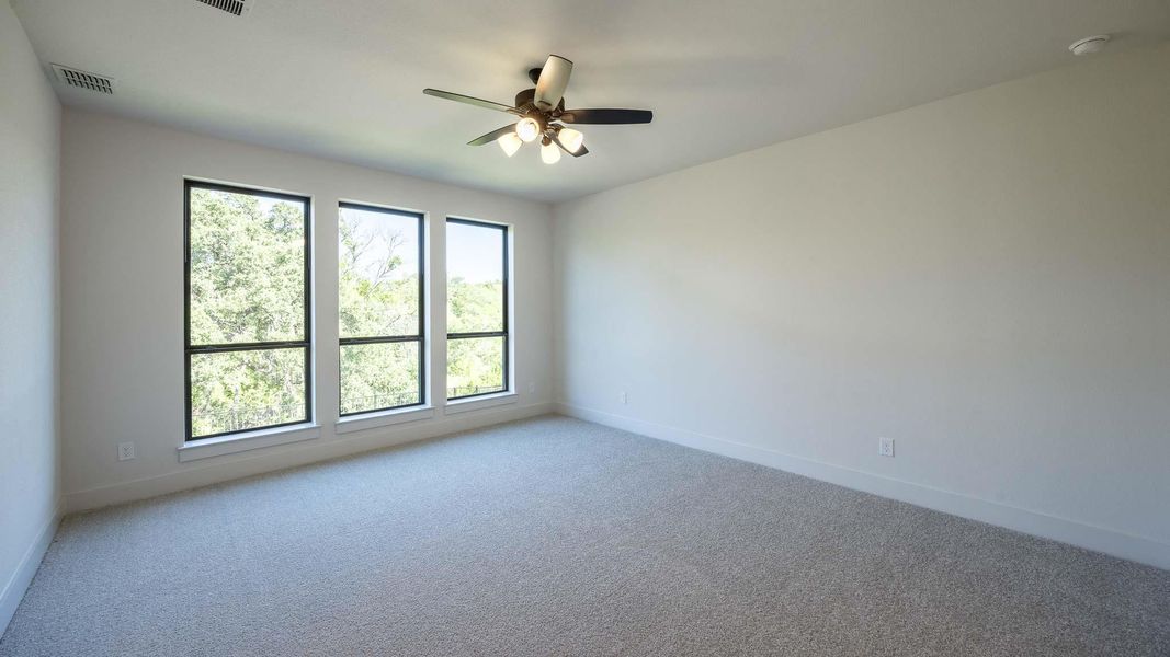 Carpeted spare room with baseboards and ceiling fan Carpeted spare room with baseboards and ceiling fan