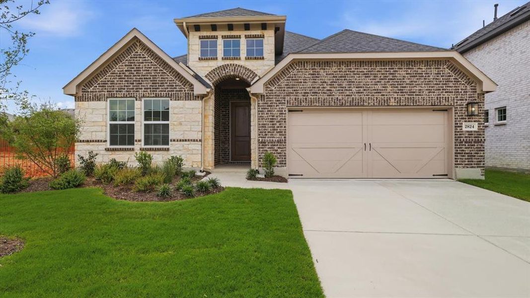 Brick and stone facade featuring a prominent arched entryway, a multi-pane window configuration, and a two-car garage with carriage-style doors Brick and stone facade featuring a prominent arched entryway, a multi-pane window configuration, and a two-car garage with carriage-style doors
