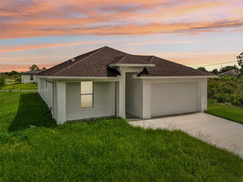 Front exterior of a new home in , Lehigh Acres, FL, highlighting curb appeal (Image 17). Front exterior of a new home in , Lehigh Acres, FL, highlighting curb appeal (Image 17).