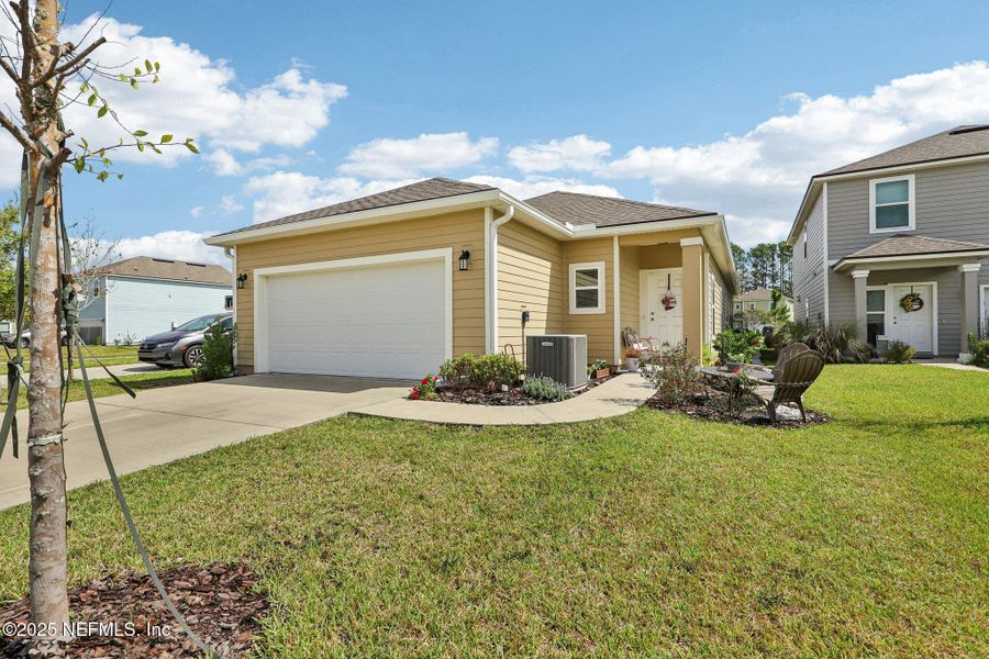 Front exterior of a new home in Tributary, Yulee, FL, highlighting curb appeal (Image 18). Front exterior of a new home in Tributary, Yulee, FL, highlighting curb appeal (Image 18).