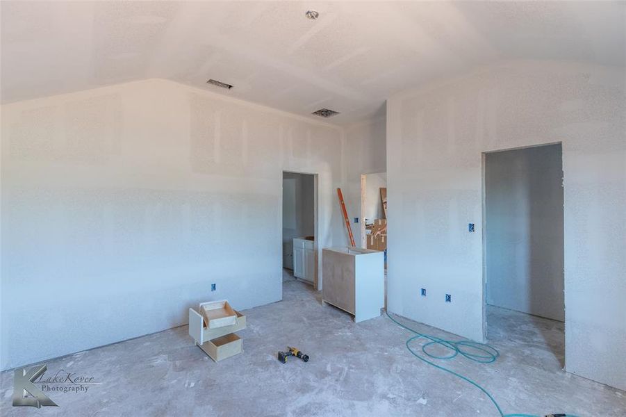 Unfurnished bedroom with lofted ceiling