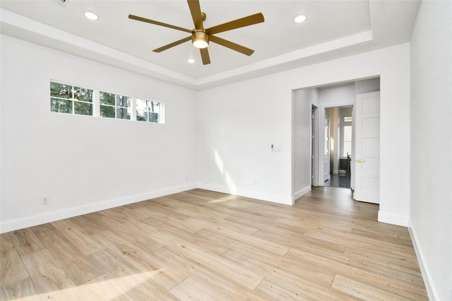 Modern luxury is found in every detail, from the designer ceiling fan to the warm wood-look flooring. The en-suite bathroom is conveniently located just steps away.