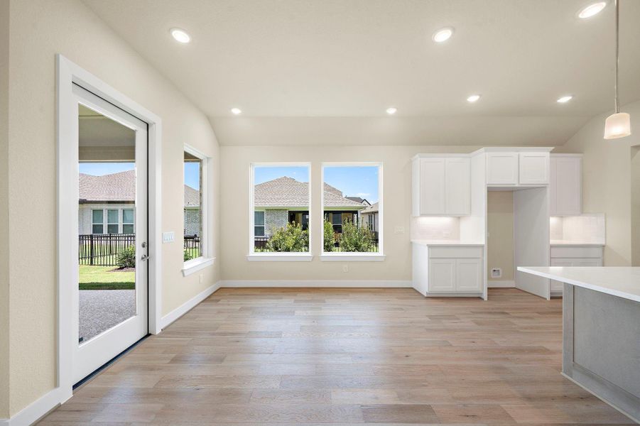 This open-concept kitchen and dining area is filled with natural light and offers clean white cabinetry, modern finishes, and direct access to the backyard — ideal for gatherings and daily living. This open-concept kitchen and dining area is filled with natural light and offers clean white cabinetry, modern finishes, and direct access to the backyard — ideal for gatherings and daily living.