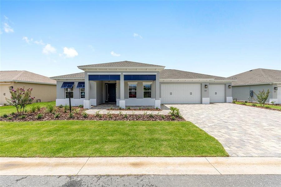 Front exterior of a new home in On Top of the World Communities, Ocala, FL, highlighting curb appeal (Image 12).