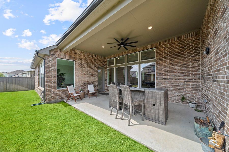 With a ceiling fan above, the patio area is comfortable for year-round enjoyment. With a ceiling fan above, the patio area is comfortable for year-round enjoyment.