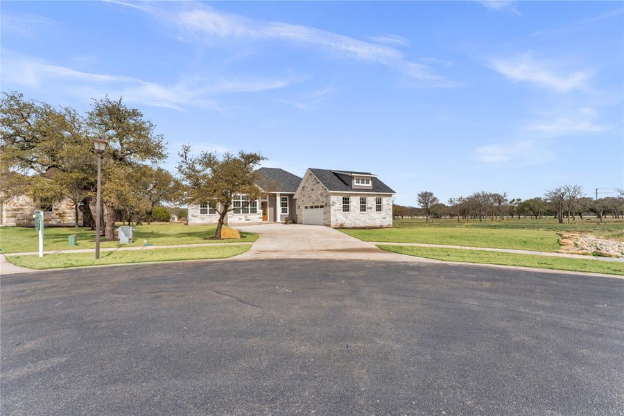 Front exterior of a new home in , Burnet, TX, highlighting curb appeal (Image 1). Front exterior of a new home in , Burnet, TX, highlighting curb appeal (Image 1).