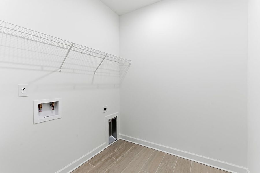 A white room with a wood floor.