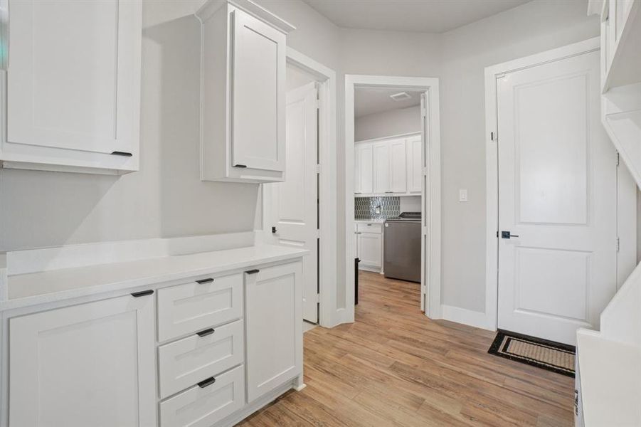 Mudroom with built-in cabinets and hall tree.