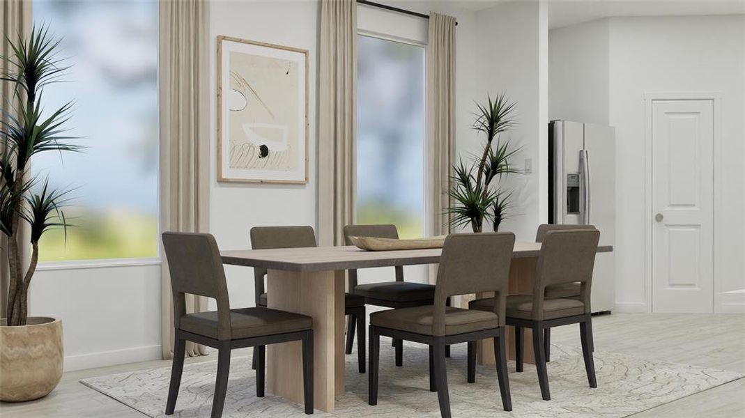 Dining room featuring light wood finished floors and healthy amount of natural light Dining room featuring light wood finished floors and healthy amount of natural light