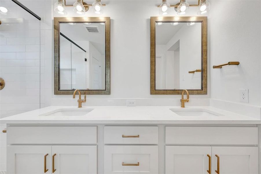 Dual vanity with white cabinetry and integrated sinks
