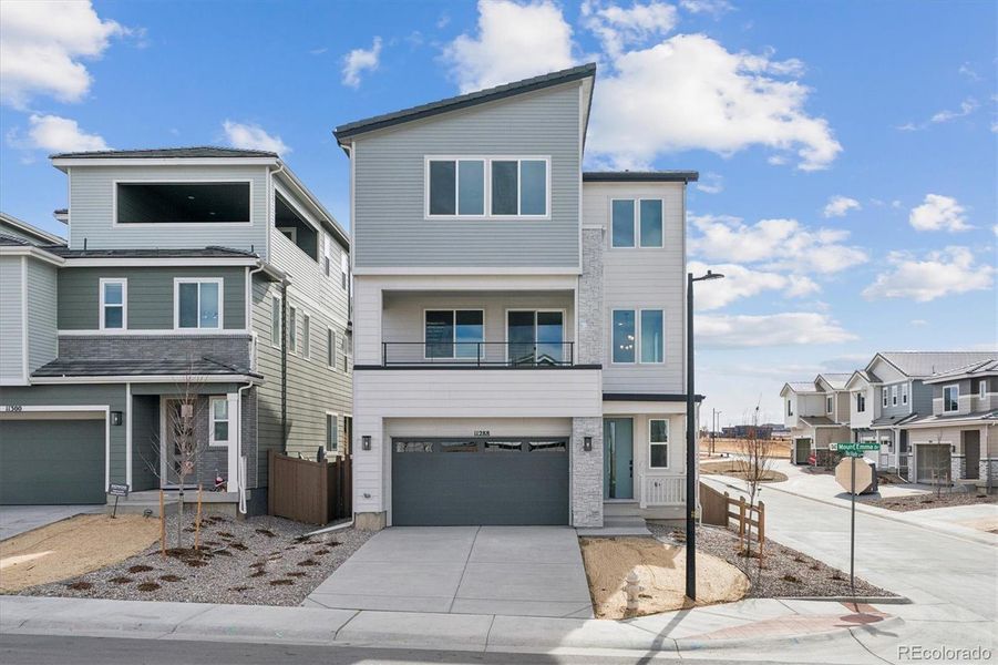 Front exterior of a new home in The Summit at Meridian, Englewood, CO, highlighting curb appeal (Image 1). Front exterior of a new home in The Summit at Meridian, Englewood, CO, highlighting curb appeal (Image 1).
