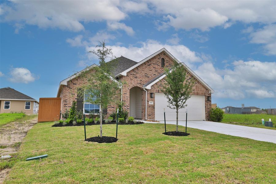Front exterior of a new home in River Ranch, Dayton, TX, highlighting curb appeal (Image 21).