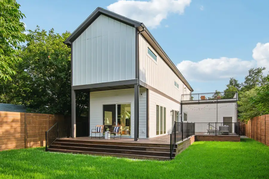 Back of house featuring a fenced backyard, a wooden deck, and board and batten siding