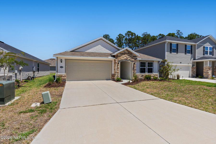 Front exterior of a new home in Copper Ridge, Jacksonville, FL, highlighting curb appeal (Image 24).