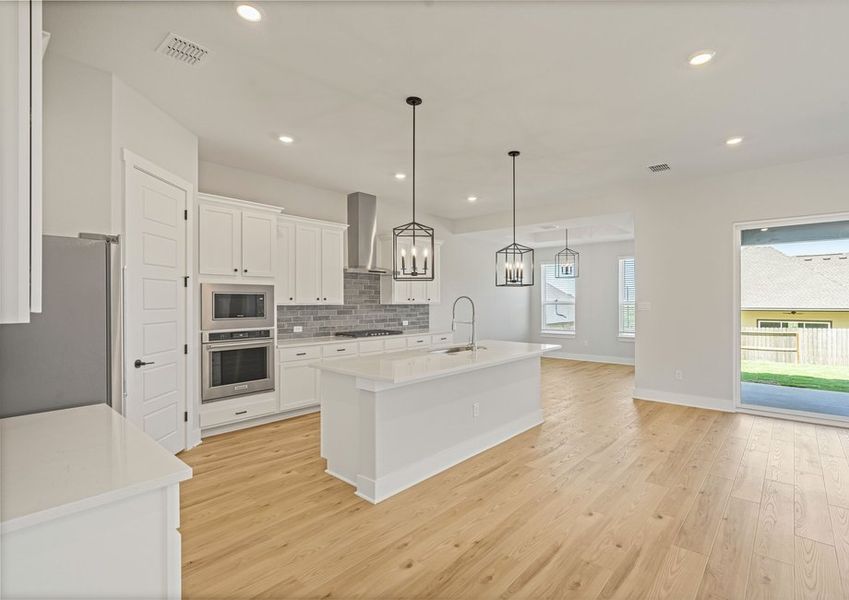 The Santos has an open floor plan that connects the kitchen, dining room and family room. The Santos has an open floor plan that connects the kitchen, dining room and family room.