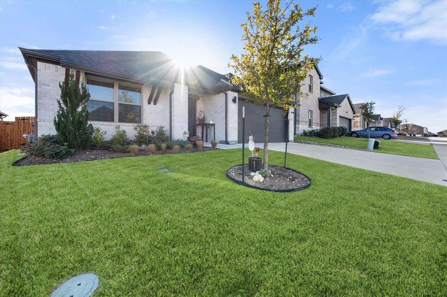 View of front of property with driveway, a front lawn, brick siding, and a garage View of front of property with driveway, a front lawn, brick siding, and a garage