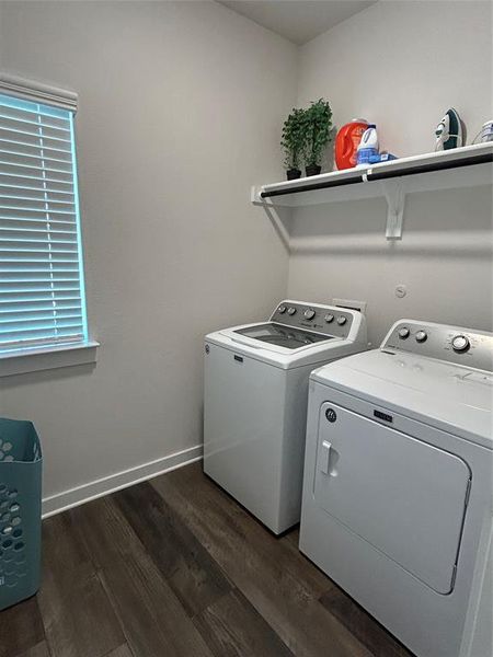 Laundry room with dark wood finished floors and separate washer and dryer Laundry room with dark wood finished floors and separate washer and dryer