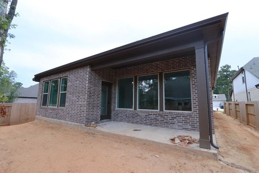 Front exterior of a new home in The Woodlands Hills 45', Willis, TX, highlighting curb appeal (Image 17). Front exterior of a new home in The Woodlands Hills 45', Willis, TX, highlighting curb appeal (Image 17).