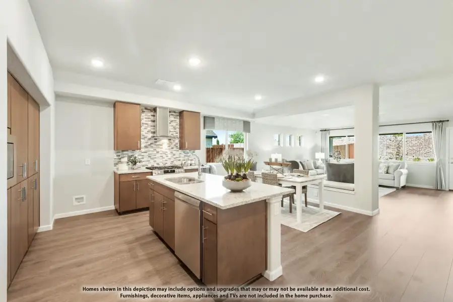Open-concept kitchen with center island, brown cabinets, tile backsplash, and hardwood floors flowing into living area