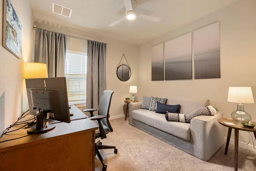 A versatile space offering both productivity and relaxation, complete with window views and a refreshing ceiling fan. A versatile space offering both productivity and relaxation, complete with window views and a refreshing ceiling fan.