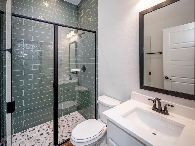 Bathroom featuring vanity and a stall shower