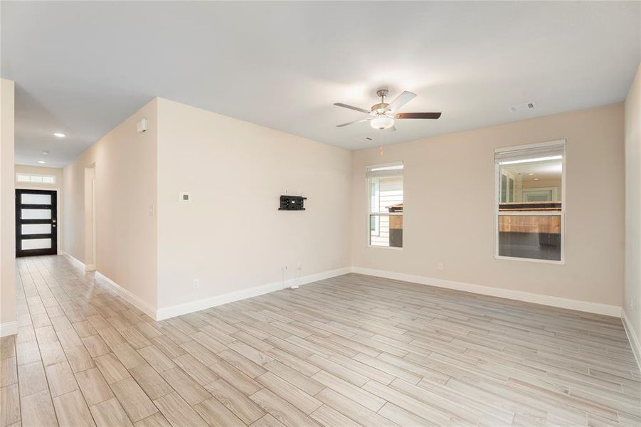 Unfurnished room with a ceiling fan, light wood-style floors, and recessed lighting