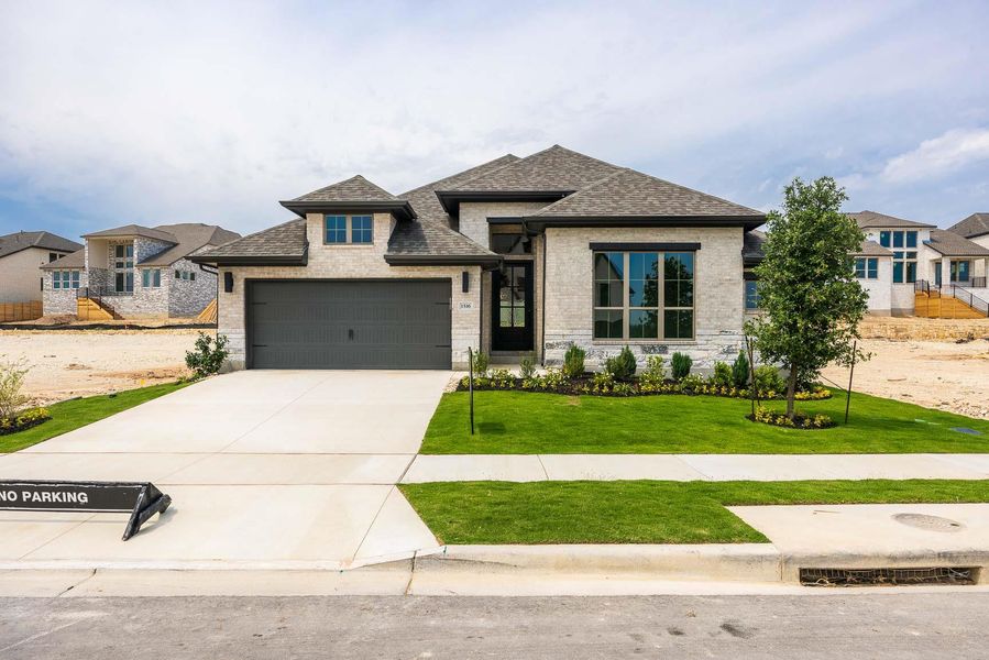 View of front of house featuring roof with shingles, concrete driveway, a front lawn, a garage, and brick siding View of front of house featuring roof with shingles, concrete driveway, a front lawn, a garage, and brick siding