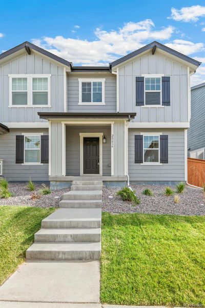 Front exterior of a new home in Sky Ranch Villas, Watkins, CO, highlighting curb appeal (Image 1).