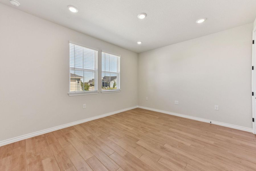Empty room with recessed lighting and light wood finished floors