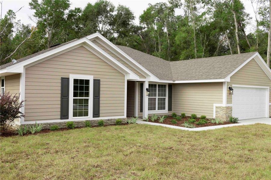 Front exterior of a new home in The Preserve at Laurel Lake, Lake City, FL, highlighting curb appeal (Image 1).
