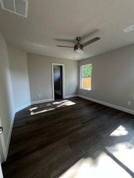 Master bedroom featuring dark hardwood / wood-style floors and ceiling fan