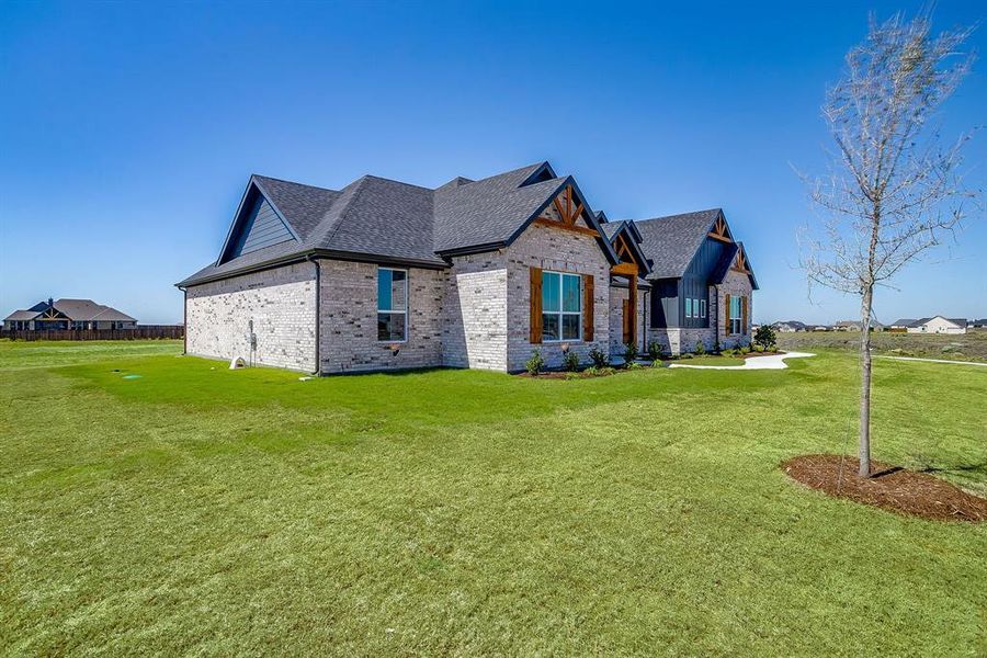 View of front of house featuring brick siding, a front yard, and roof with shingles View of front of house featuring brick siding, a front yard, and roof with shingles